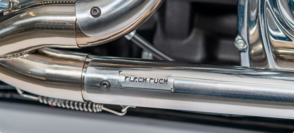 Engraved Black Duck Tech logo on a high-performance exhaust for Harley-Davidson