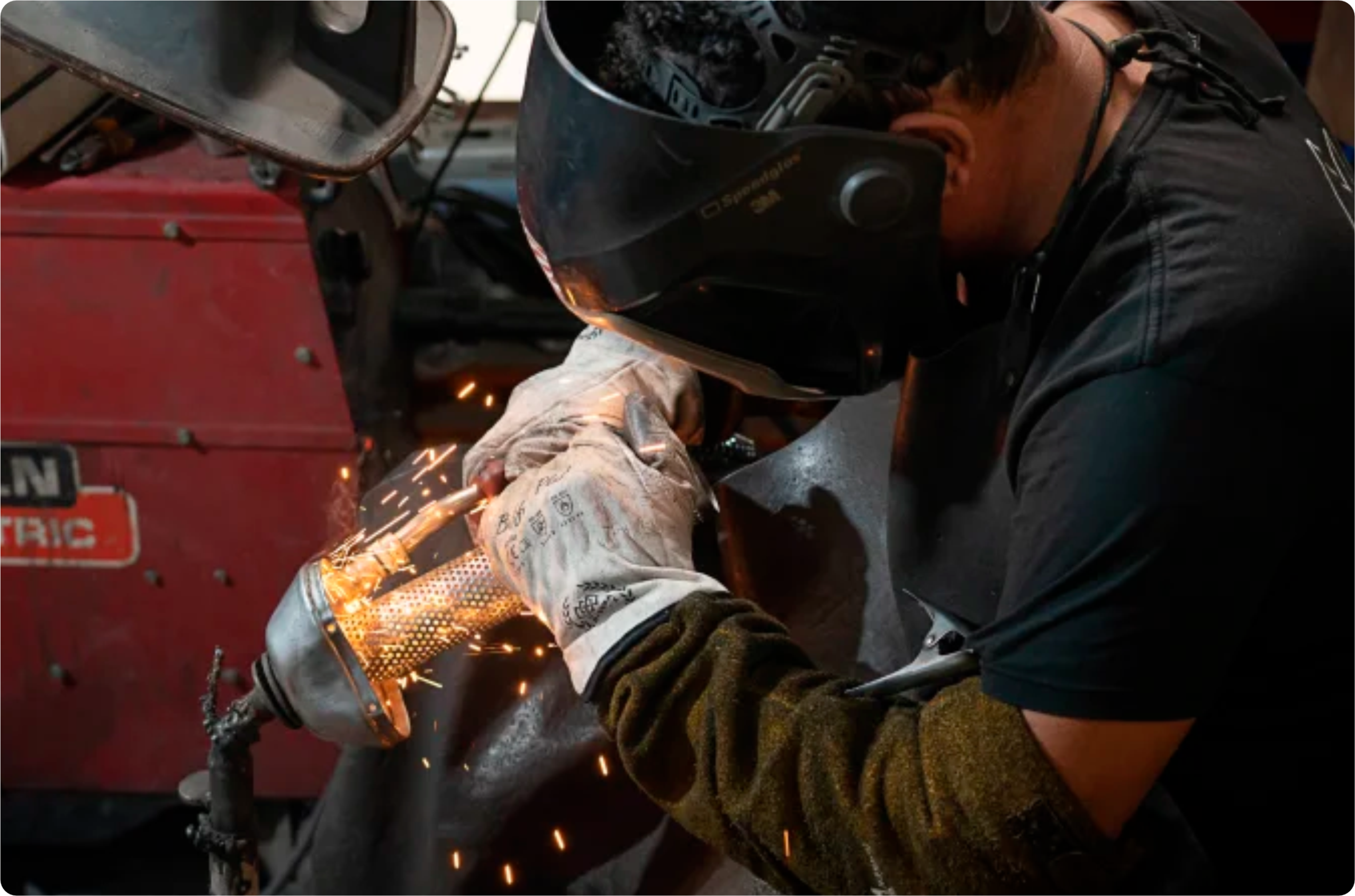 Welder crafting a high-performance Black Duck Tech exhaust for Harley-Davidson